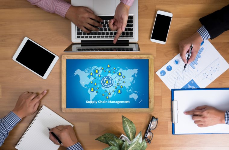 Desk with laptop, phones and business documents.