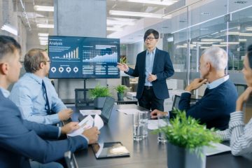 Image of man presenting data to team