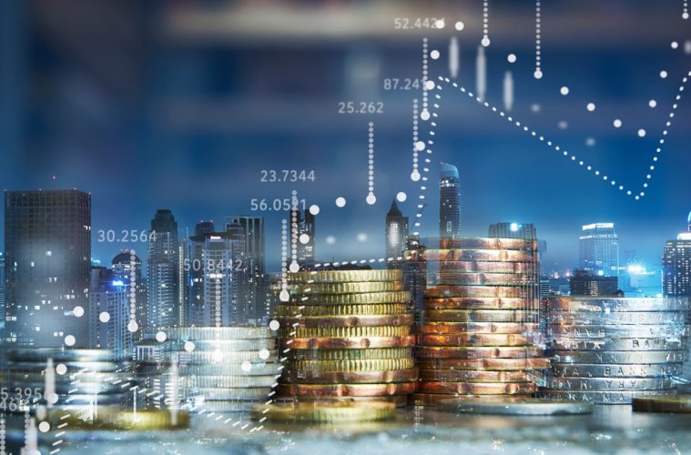 Picture of coins against city skyline
