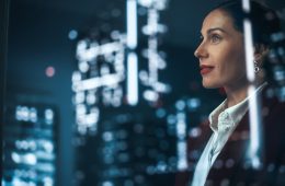 Business women in office looking out of window