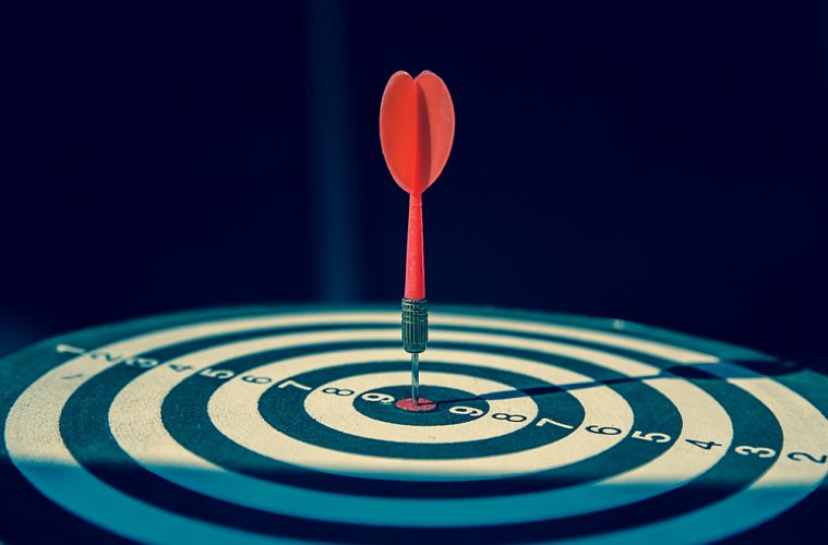 Forecast accuracy concept with dartboard